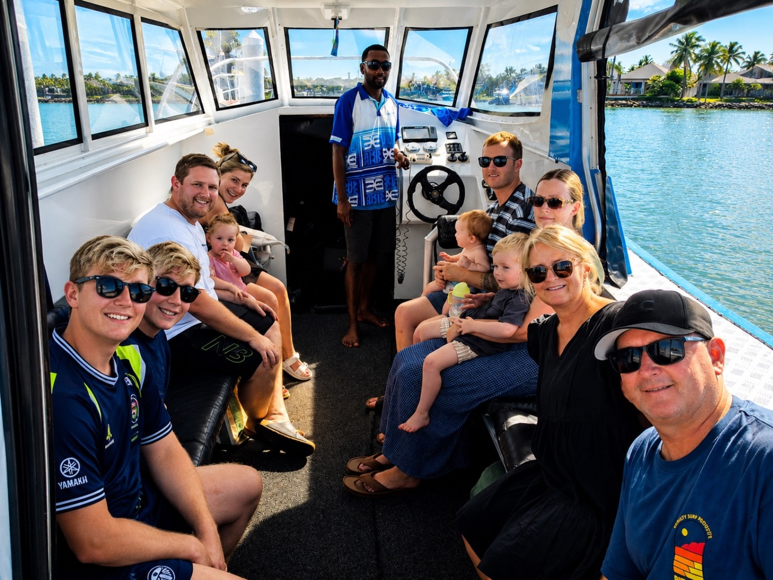 Family group travelling with skipper aboard a Bluewave Fiji speedboat