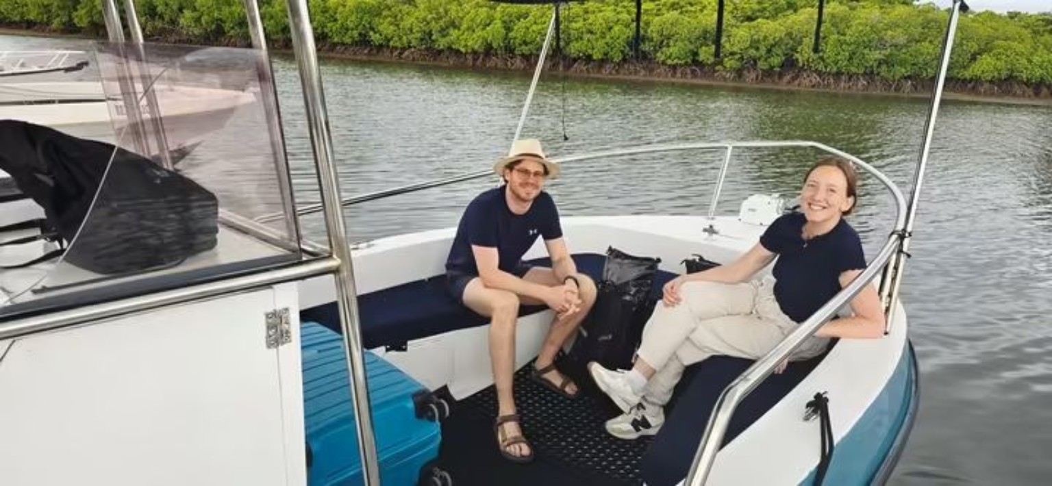 Couple relaxing on the front deck during a private boat transfer
